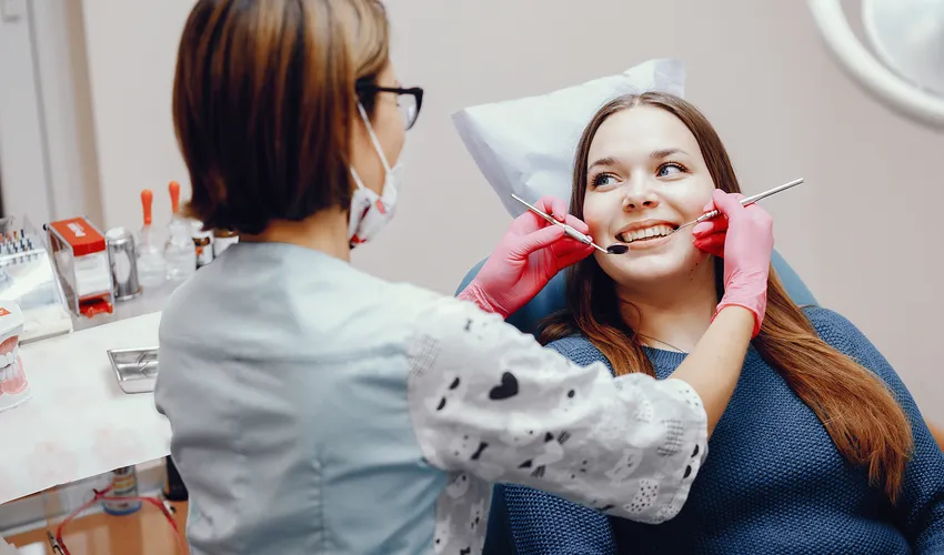 dentist checking patient's teeth